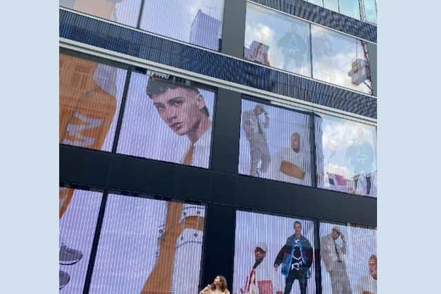 Angela in front of her work in Oxford Street