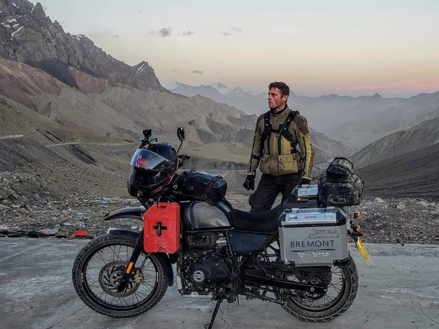 Jack standing atop a freezing mountain pass at dusk, in the far south of Xinjiang Province and within sight of K2 (C) Simon Double