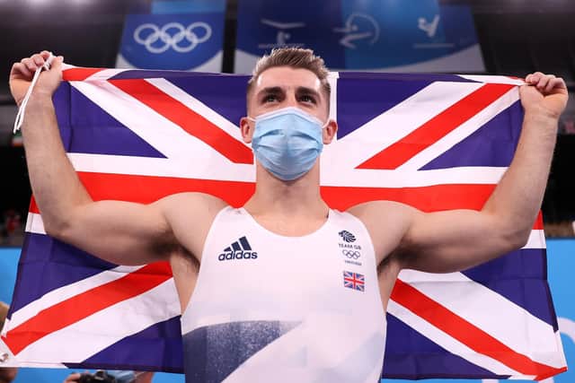 Max Whitlock celebrates after he was crowned Olympic pommel horse champion for a second time