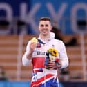 Hemel Hempstead's Max Whitlock shows off his gold medal after retaining his Olympic pommel horse title in Tokyo. Pictures by Jamie Squire/Getty Images