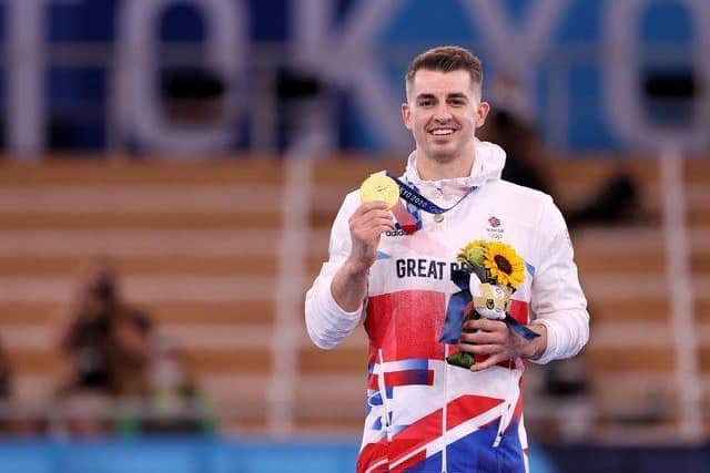 Hemel Hempstead's Max Whitlock shows off his gold medal after retaining his Olympic pommel horse title in Tokyo. Pictures by Jamie Squire/Getty Images