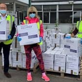 Volunteers, including Leader of Hertfordshire County Council, Richard Roberts, sorting through donations at the temporary donation sorting centre