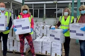 Volunteers, including Leader of Hertfordshire County Council, Richard Roberts, sorting through donations at the temporary donation sorting centre