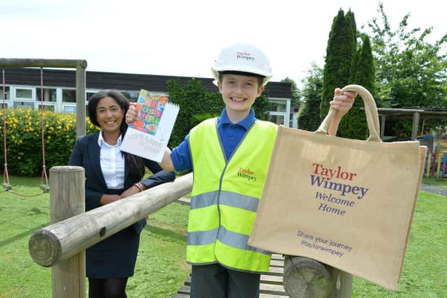 Jayden Spencer with his prizes alongside Robyn Morgan Campbell from Taylor Wimpey