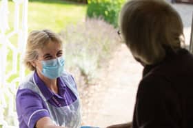 A Rennie Grove nurse greets a patient at their home