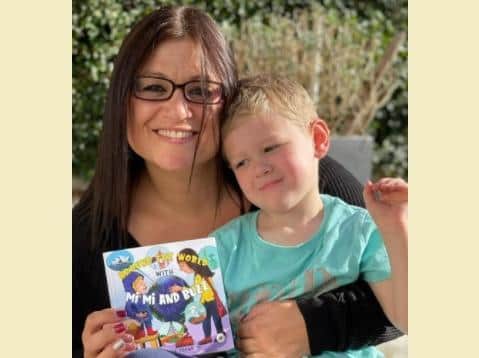 Amanda and Leighton with her book, Around the World with Mi Mi and Buzz