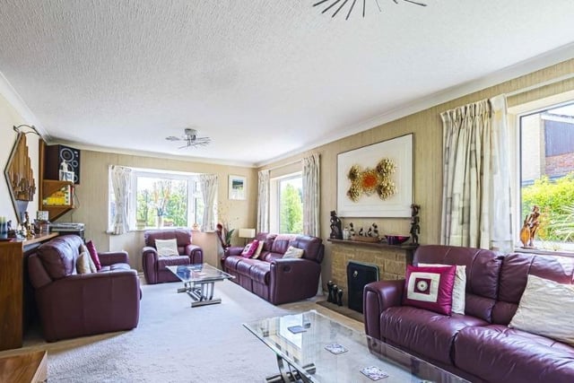 One of three reception rooms inside the home, this one includes a fireplace.