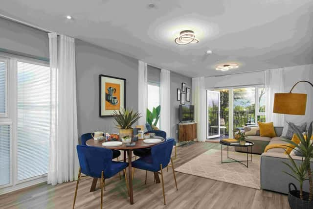 Open-plan living/dining room leading to balcony at the new show apartment at Bellway's Millworks