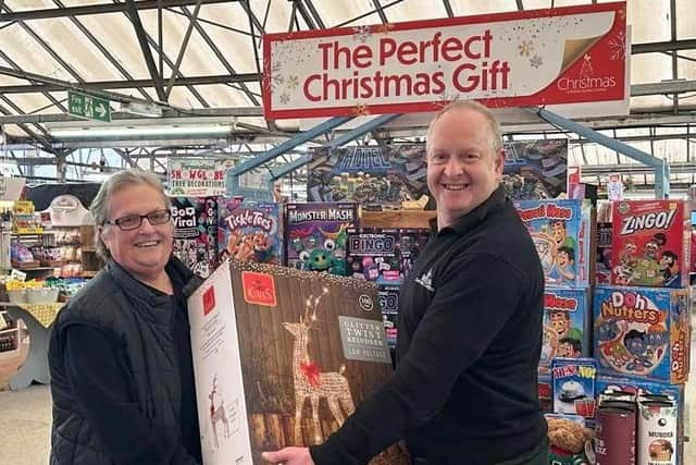 Photo caption: Julie Steer receives the light up reindeer from Chipperfield Garden Centre
