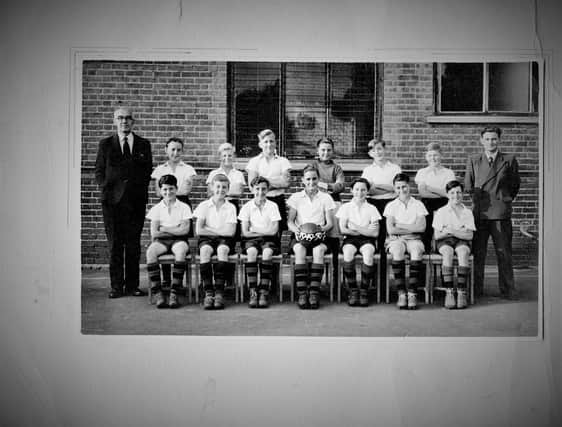 The 1949 Victoria School football team. Former member Ken Potter would like to know the names of the two boys on the right in the front row and the sports master