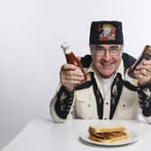'I ever did a PhD in anything, it would be indolence': Danny Baker with a sausage sandwich (photo: Steve Ullathorne)