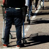 Shoppers queue using safe distance measures at Waitrose supermarket in Rushden, England (Photo: David Rogers/Getty Images)