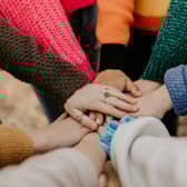 Group of people showing support to one another.