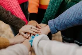 Group of people showing support to one another.