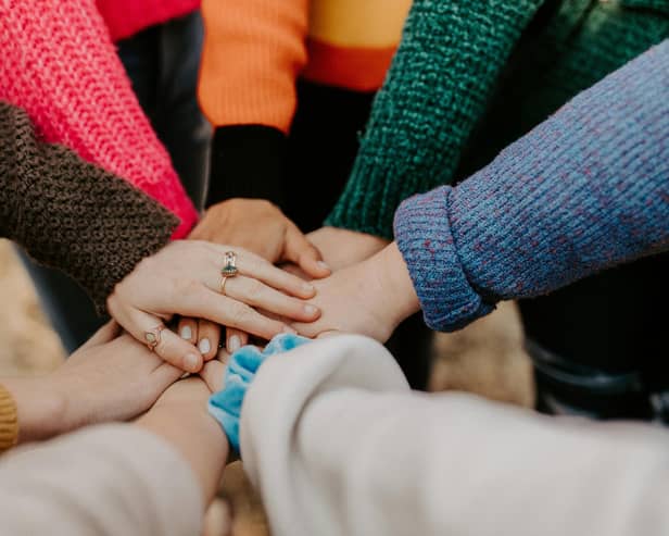 Group of people showing support to one another.