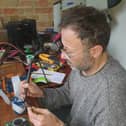 One of the Repair Cafe volunteers repairing by changing a component on a circuit board