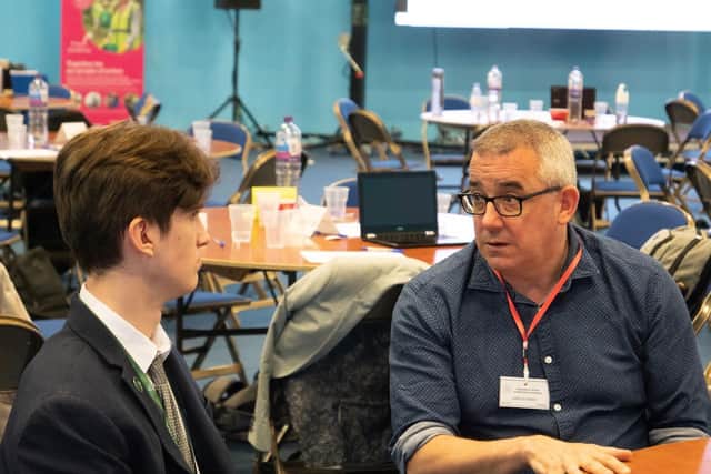 Gareth Owen OBE, humanitarian director at Save the Children, speaking with a student.