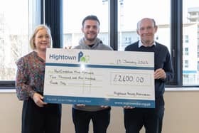 Louis Breese of Hertfordshire Mind Network (centre) accepts a cheque from Hightown's charity committee chair Vicki McDonald and chief executive David Bogle