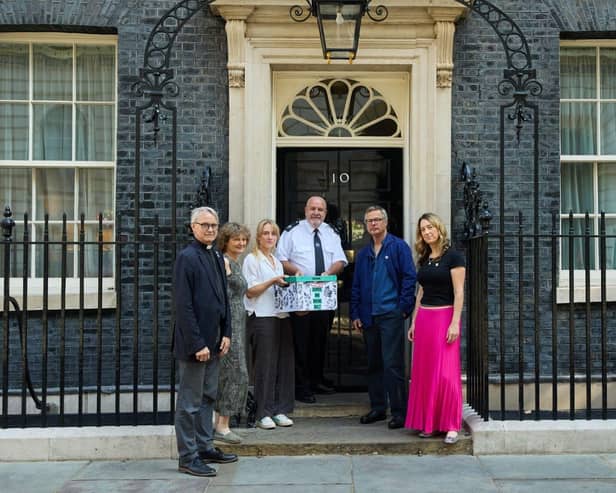 Campaigners pose in front of 10 Downing St.