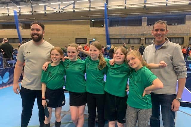The team with their coaches at the tournament.
