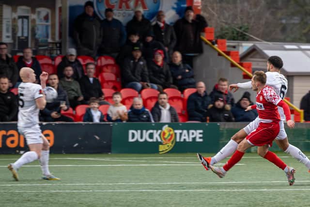 George Williams sees his shot blocked by a defender during Saturday’s defeat. Photo: HHTFC.