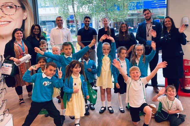 Pupils from Year 1, Jupiter Primary School, (L to R back row) Ms Ria Perry, Year 1 Teacher, Geeta Patel, Audiology Director, Ash Patel, Ophthalmic Director, Shyam Suchak, Ophthalmic Director, Louise England, General Manager, Amy Patel, Optometrist, Harry Hutchings, Hearcare Assistant & Priti Amrania, PR & Community Engagement Lead