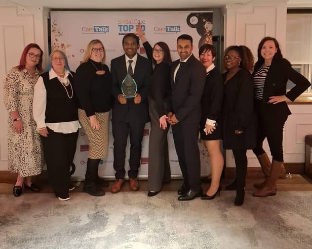 Francis Zvoma with his managers at the award ceremony.