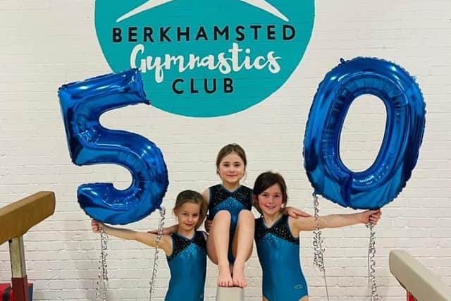 Gymnasts celebrate the milestone