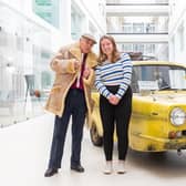 Del Boy lookalike posing with a smiling employee