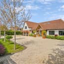 This beautiful contemporary family home is located on a 0.6 acre plot on a private road, backing on to fields.