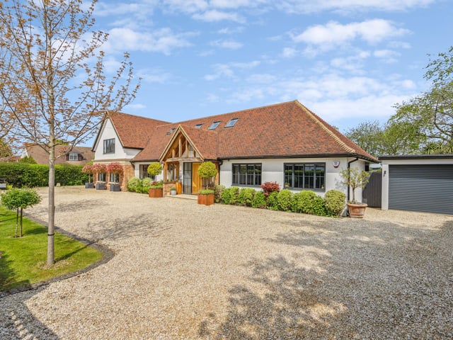 This beautiful contemporary family home is located on a 0.6 acre plot on a private road, backing on to fields.