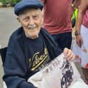 Harry, with a picture of him in his racing days, when he was surprised with a trike ride by DMR last month.