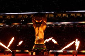 AL KHOR, QATAR - NOVEMBER 25: A fire display surrounds a giant FIFA trophy prior to the match between the United States and England during the FIFA World Cup Qatar 2022 Group B match between England and USA at Al Bayt Stadium on November 25, 2022 in Al Khor, Qatar. (Photo by Elsa/Getty Images)