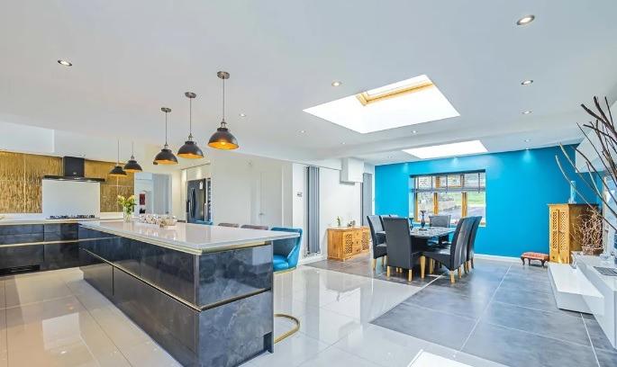 The ultra-modern, open plan kitchen connects to the dining and breakfast area.