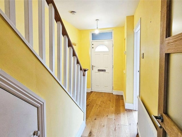Stepping in, you will be greeted by a charming entrance hall with smart wooden floors leading to an open plan reception area.