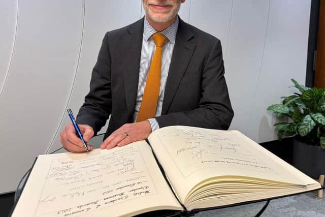 Darren Roe signs the winners' book
