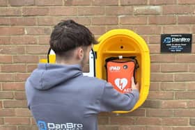 Danbro electrical apprentice helping on the installation of the defibrillator