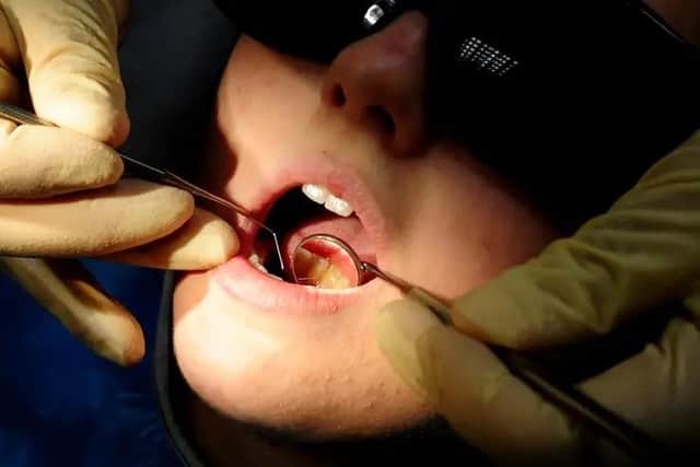 Pictured: Young person at a dentist
