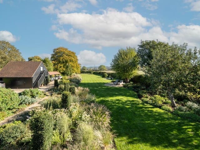 The property includes gardens covering three-quarters of an acre landscaped by an award-winning designer