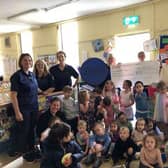 Trish from Tesco presenting the cheque to Leverstock Green Playgroup