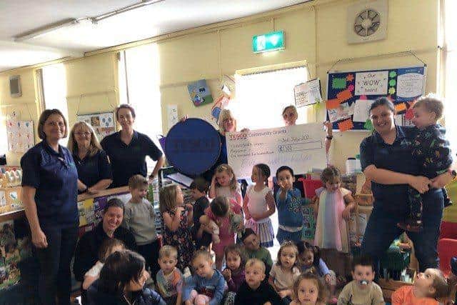 Trish from Tesco presenting the cheque to Leverstock Green Playgroup