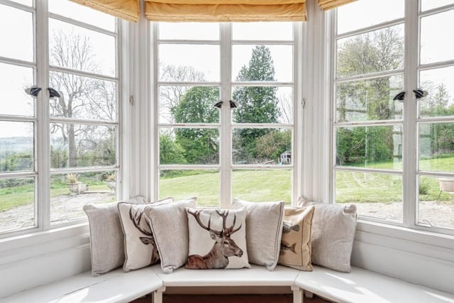 The drawing room has a bay window that offers views out to the garden and lets the outside in.