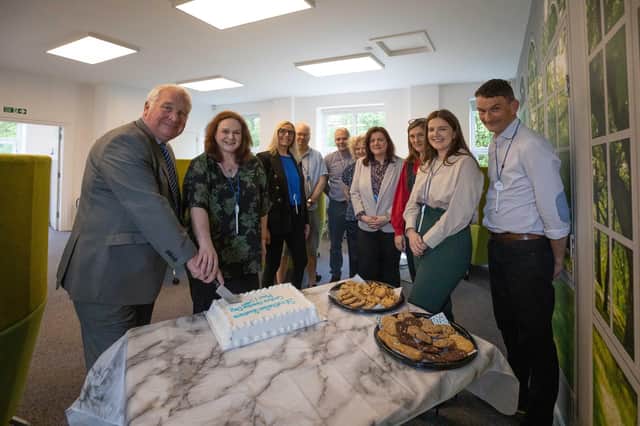 MP Sir Mike Penn cuts the cake at the official opening of the new Strathallan Business Centre