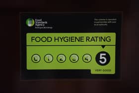 A Food Standards Agency rating sticker on a window of a restaurant