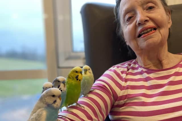 Water Mill House resident Judith Oates with her new feathered friends.