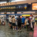 Rail passengers wait for announcements at Euston train station