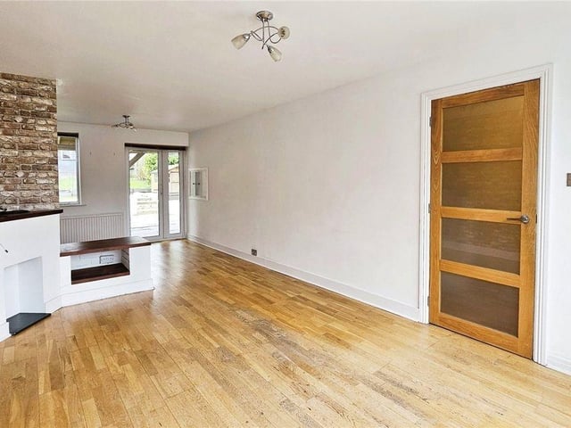 The open-plan living area features exposed brick walls, wood floors and access to a large garden.