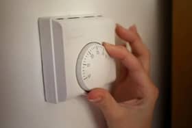 Pictured: Person moving thermostat