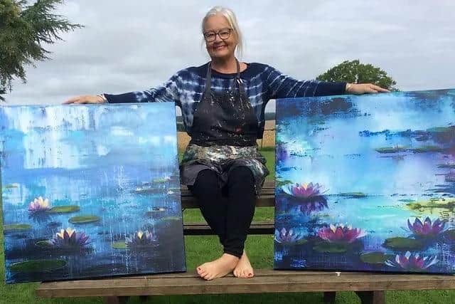 Gill with some of her paintings.