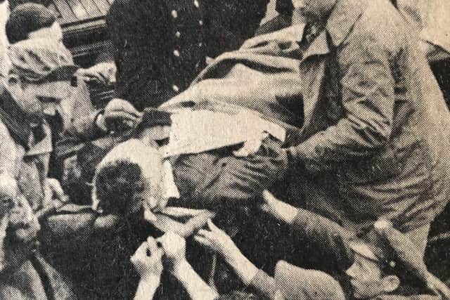 “That's him with no hat on in the middle, passing a stretcher through.” said Neil.